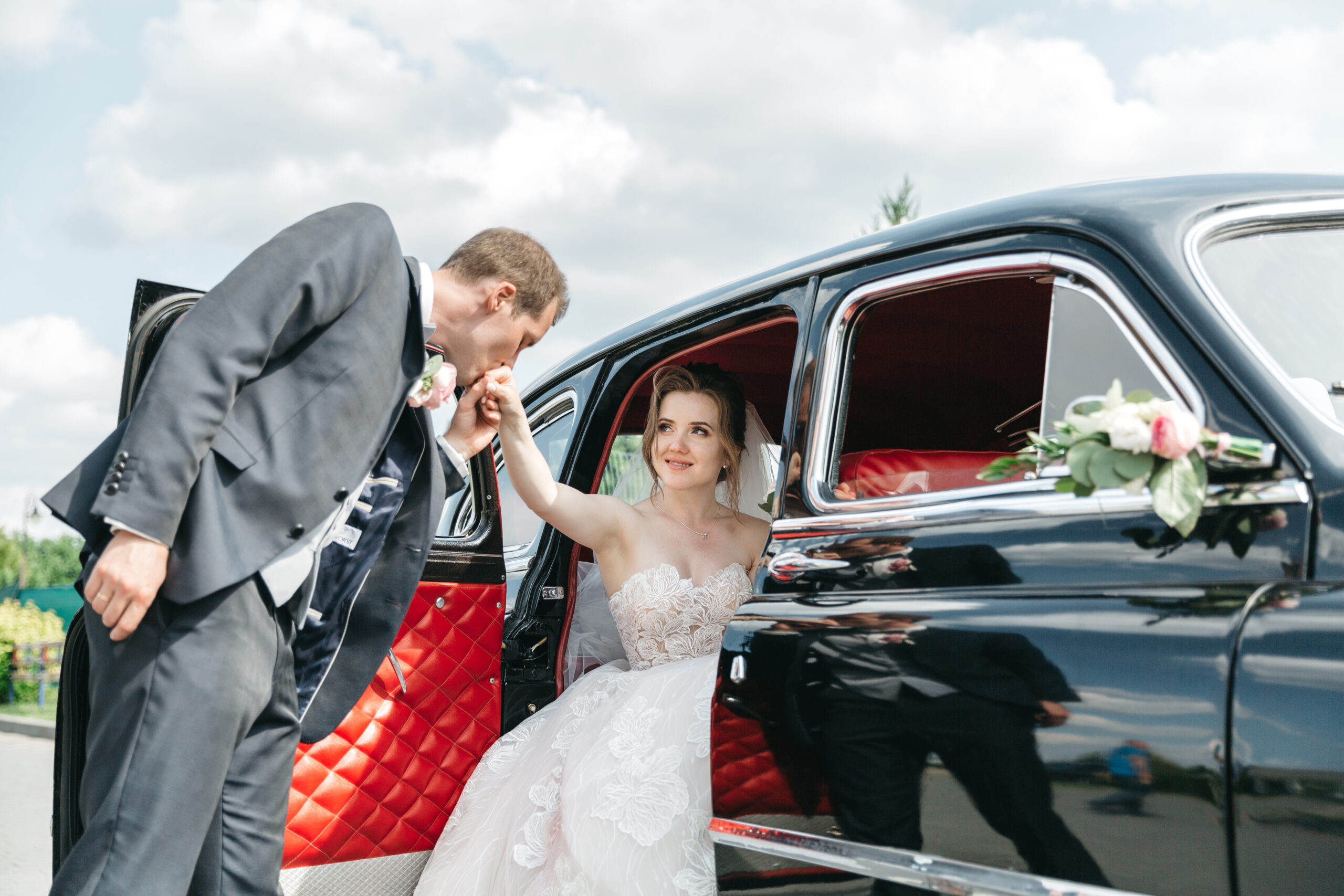 groom kisses his beloved hand scaled